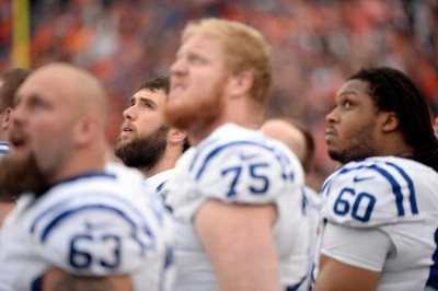 Andrew Luck listens to the National Anthem in the same spot where he operated successfully today - behind his offensive line.